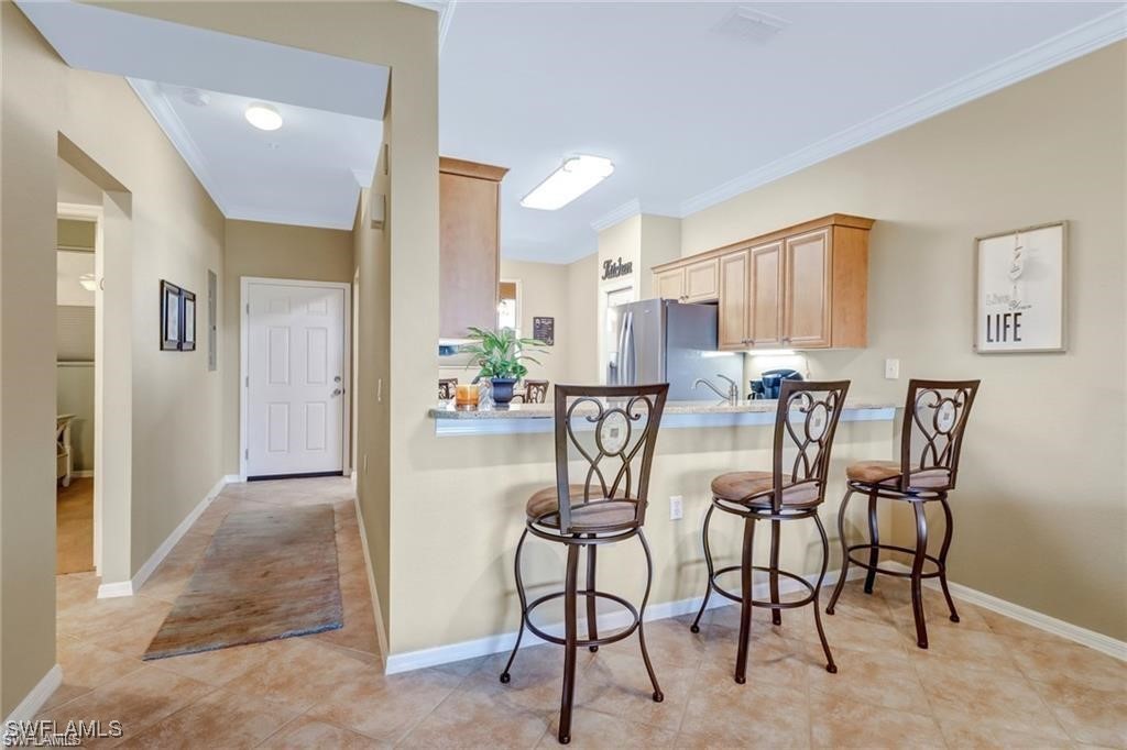 8261 Pathfinder Loop, Unit 745 Fort Myers, FL 33919 - Photo 3 of 22 a view of a dining room with furniture