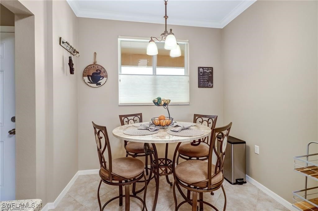 8261 Pathfinder Loop, Unit 745 Fort Myers, FL 33919 - Photo 5 of 22 a view of a dining room that has a table and chairs
