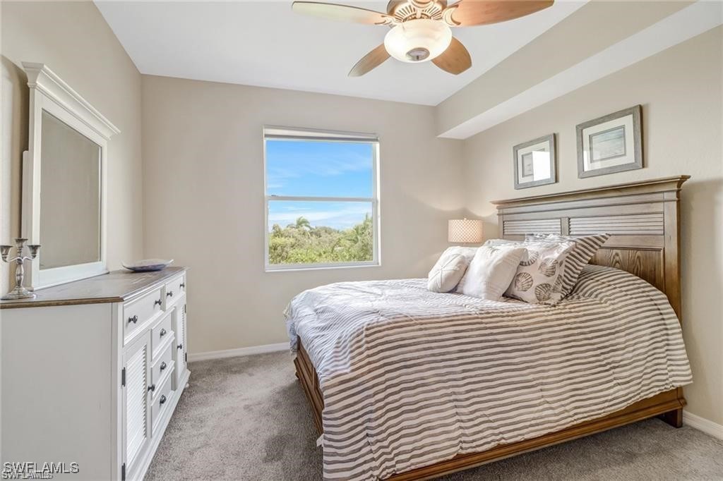 8261 Pathfinder Loop, Unit 745 Fort Myers, FL 33919 - Photo 8 of 22 a bedroom with a bed and a chandelier