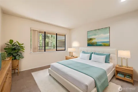 a bedroom with a bed and a potted plant