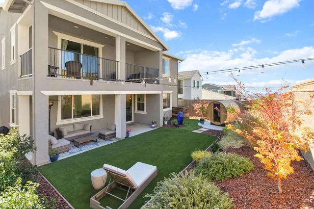 a view of a house with backyard porch and sitting area