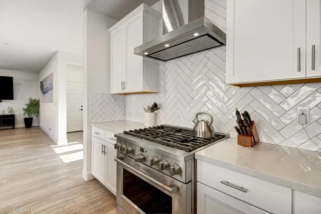 a large kitchen with kitchen island a sink table and chairs