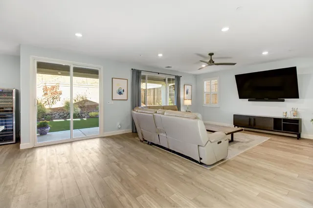 a kitchen with stainless steel appliances kitchen island granite countertop a table chairs and a refrigerator
