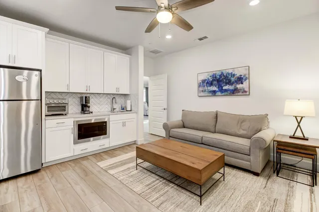 a living room with furniture and a chandelier