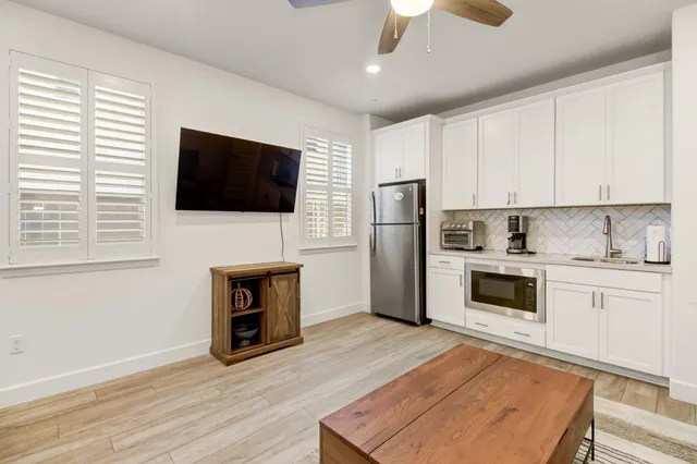 a hallway with a sink cabinetry and stove