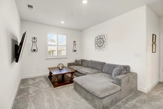 a bedroom with a bed dresser and a window