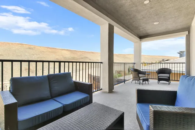 a bedroom with a baby bed a couch and dresser