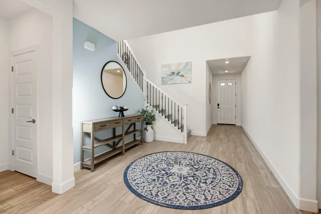 a view of entryway with wooden floor and front door
