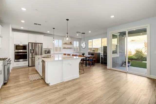 a kitchen with stainless steel appliances granite countertop a stove and a wooden cabinets