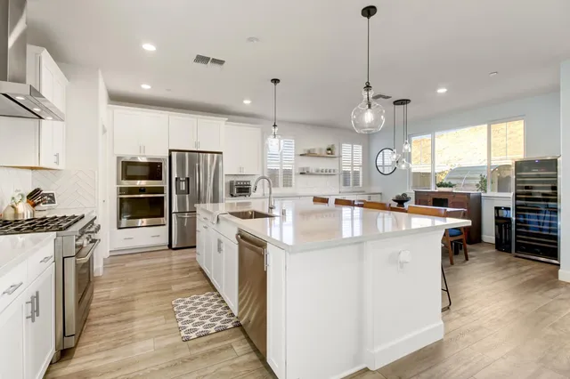 a kitchen with granite countertop a stove and a refrigerator