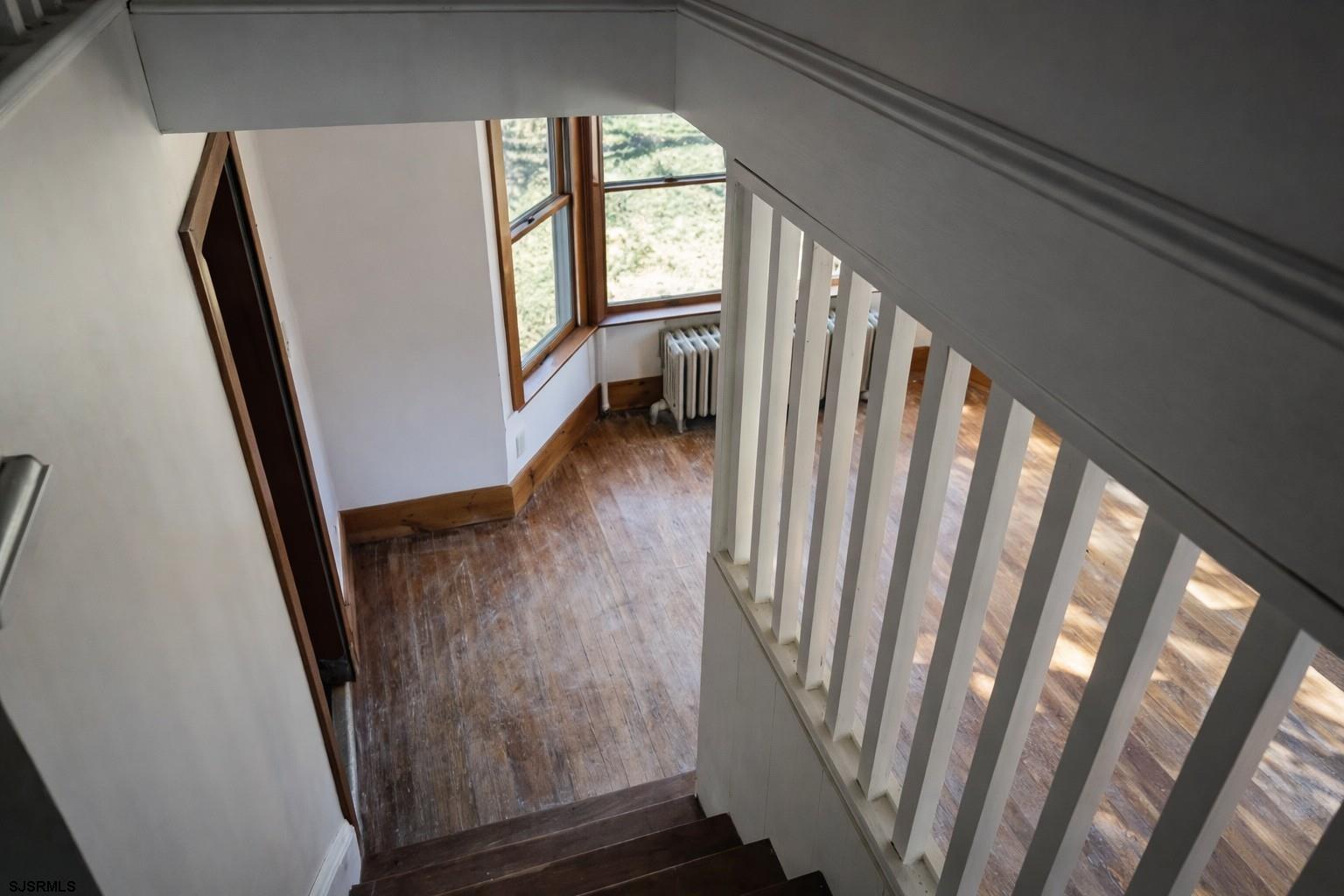 639 Chestnut Neck Road Port Republic, NJ 08241 - Photo 14 of 26 a view of a hallway with wooden floor and stairs