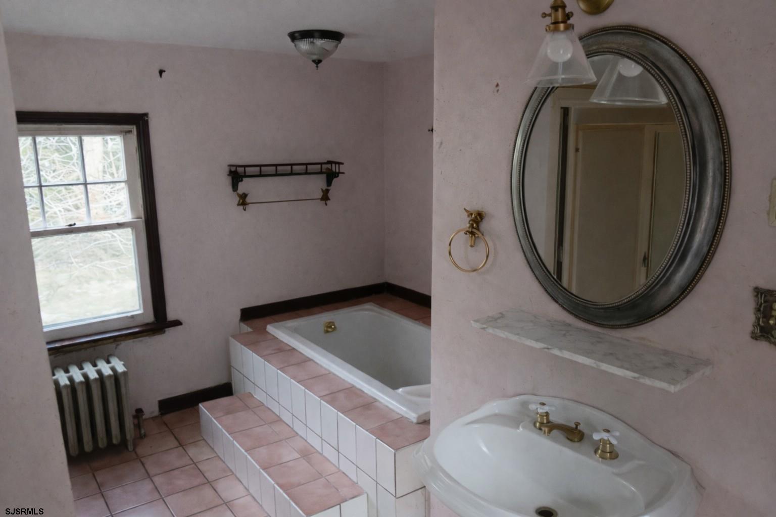 639 Chestnut Neck Road Port Republic, NJ 08241 - Photo 21 of 26 a bathroom with a sink a bathtub and a mirror