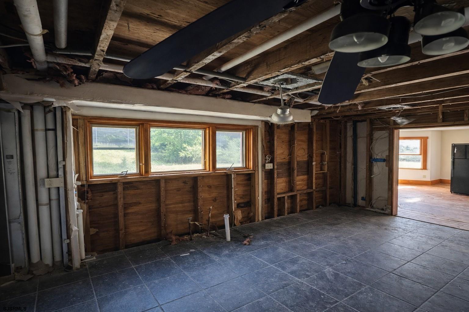 639 Chestnut Neck Road Port Republic, NJ 08241 - Photo 8 of 26 a view of an empty room with wooden walls