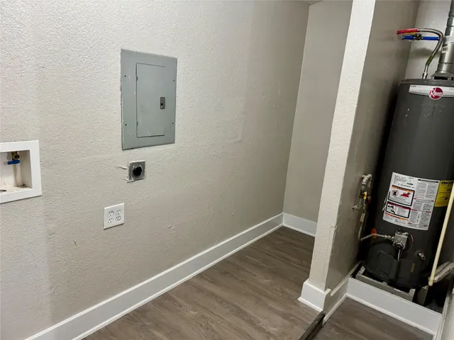 a view of a hallway with wooden floor and closet