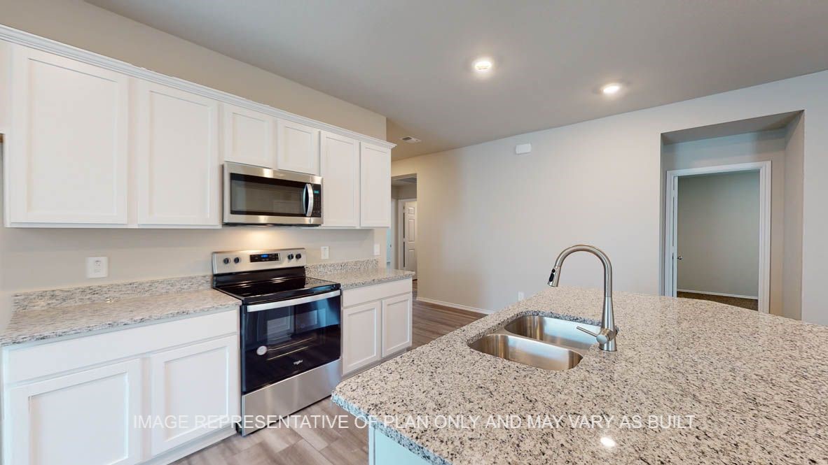 3017 Taddy Road Lorena, TX 76655 - Photo 2 of 24 a kitchen with a stove a sink and a microwave