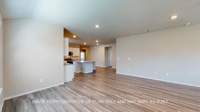 a view of a kitchen with wooden floor and a kitchen