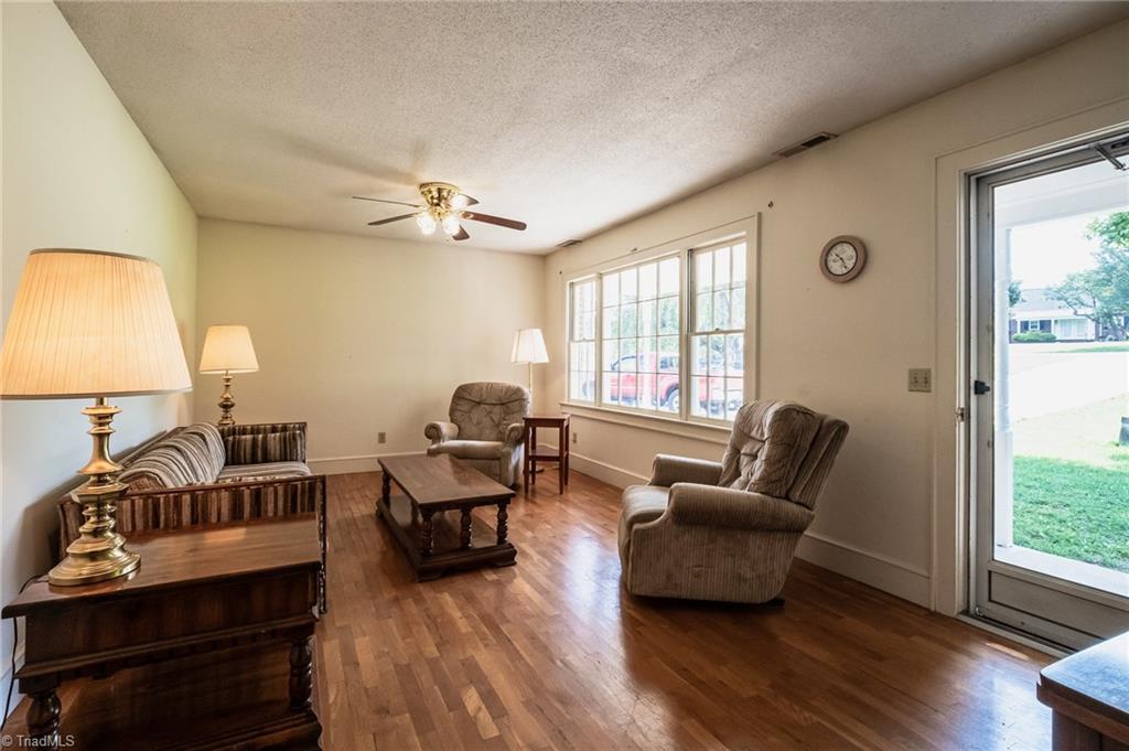 3575 Austin Traphill Road Elkin, NC 28621 - Photo 6 of 30 Living room features hardwood floors and door leading to covered front porch and yard.