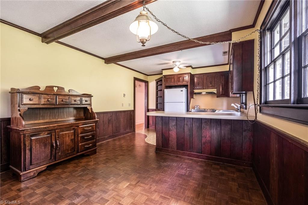 3575 Austin Traphill Road Elkin, NC 28621 - Photo 8 of 30 The kitchen features an eat-in dining room with wood parkay floor and wooden ceiling beams.