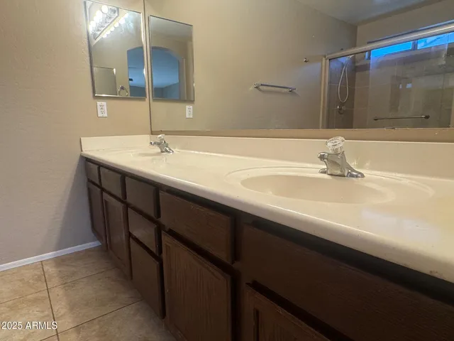a bathroom with a double vanity sink and a mirror
