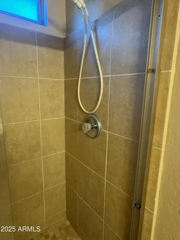 a view of an empty room with a bathroom and a sink
