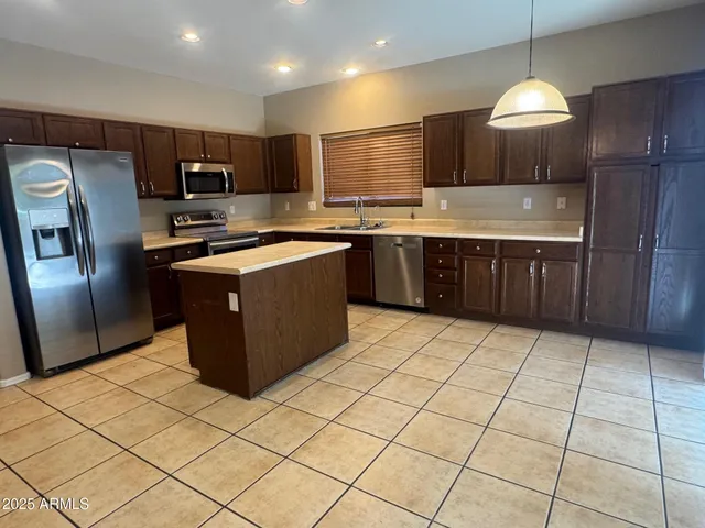 a kitchen with stainless steel appliances granite countertop a sink counter space cabinets and a counter top space