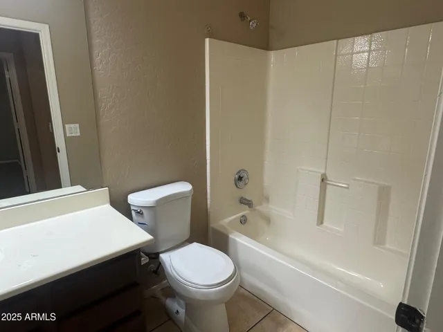 a white toilet sitting next to a bath tub