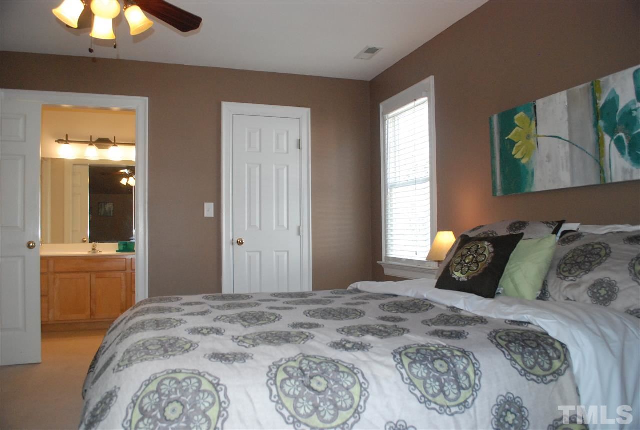 426 Morrison Avenue Raleigh, NC 27608 - Photo 22 of 25 a bedroom with a bed and a chandelier