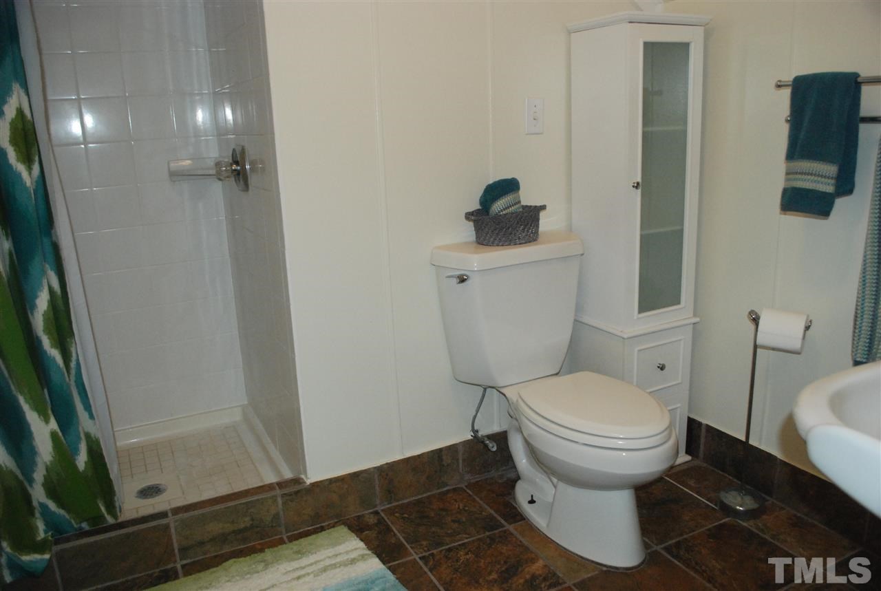 426 Morrison Avenue Raleigh, NC 27608 - Photo 25 of 25 a bathroom with a toilet and a shower