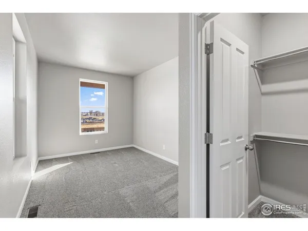 a view of an empty room and a window