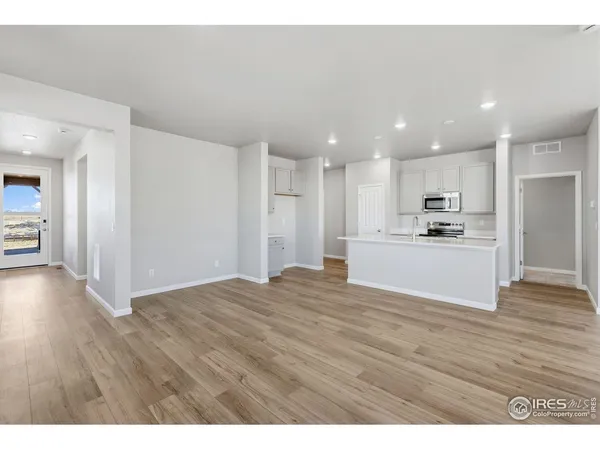 a view of a kitchen with a sink and a refrigerator