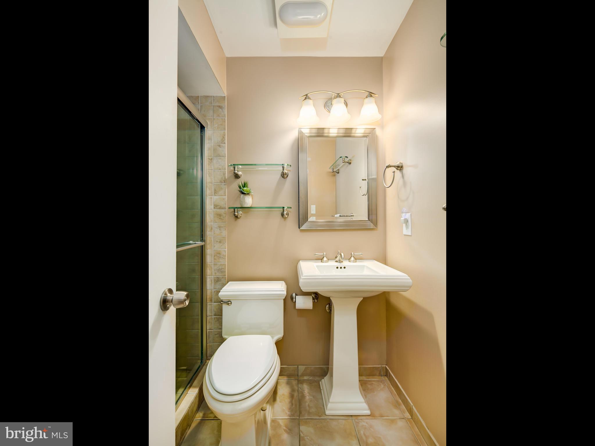 199 Summit Hall Road Gaithersburg, MD 20877 - Photo 14 of 30 a bathroom with a sink a toilet and mirror