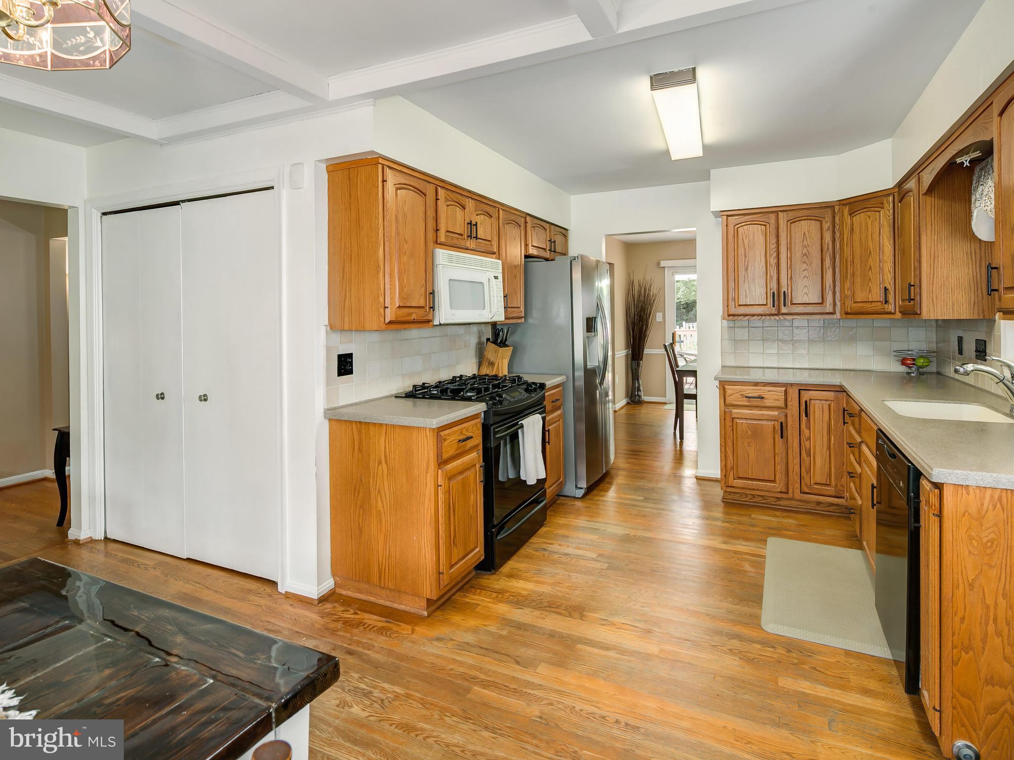 199 Summit Hall Road Gaithersburg, MD 20877 - Photo 9 of 30 a kitchen with stainless steel appliances granite countertop a stove a sink and a refrigerator