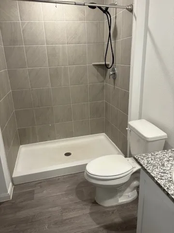 a bathroom with a toilet and a shower