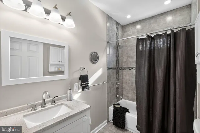 a bathroom with a double vanity sink toilet and shower