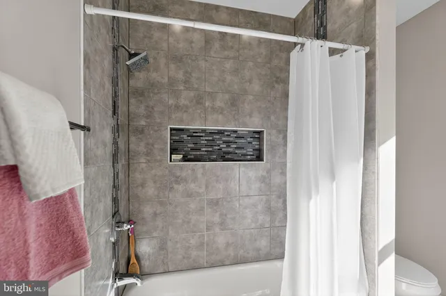 a bathroom with a shower and a sink