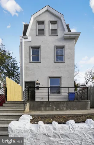 a front view of a house with large windows