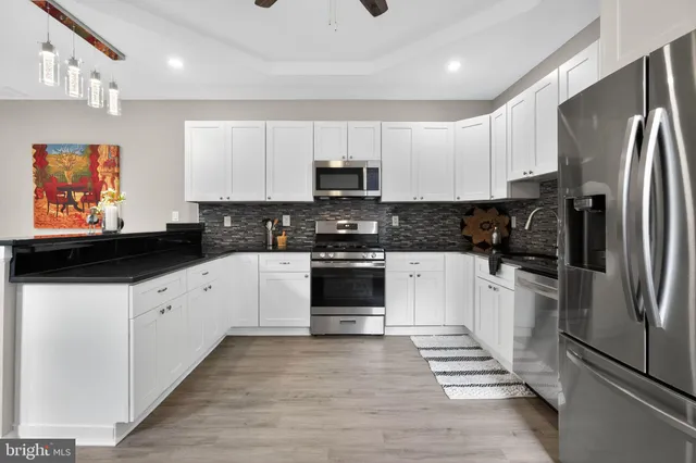a kitchen with a refrigerator stove and sink