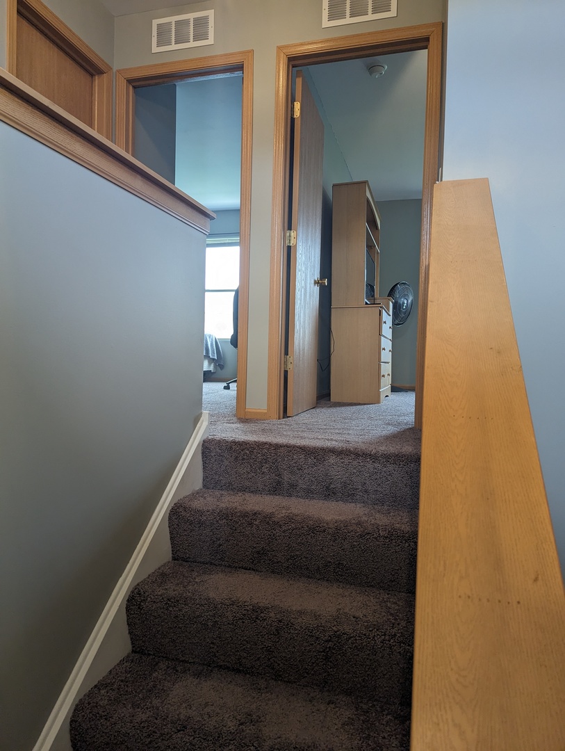 25196 Faraday Road, Unit 1 Manhattan, IL 60442 - Photo 14 of 19 a view of staircase with white walls