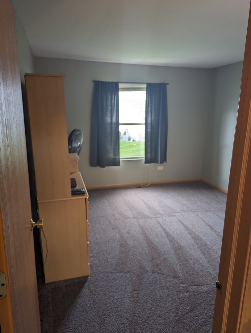 25196 Faraday Road, Unit 1 Manhattan, IL 60442 - Photo 4 of 19 an empty room with windows