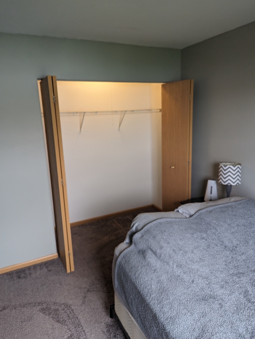 25196 Faraday Road, Unit 1 Manhattan, IL 60442 - Photo 6 of 19 a bedroom with a bed and wooden floor