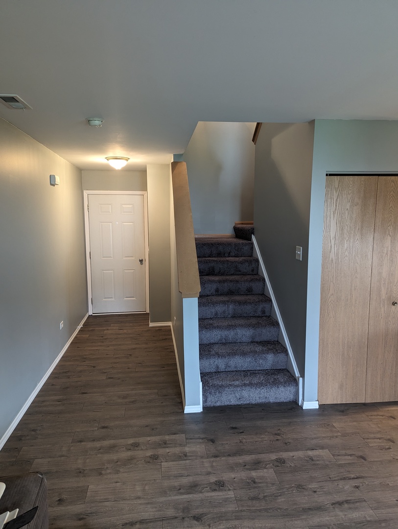25196 Faraday Road, Unit 1 Manhattan, IL 60442 - Photo 10 of 19 a view of a hallway with wooden floor and entryway
