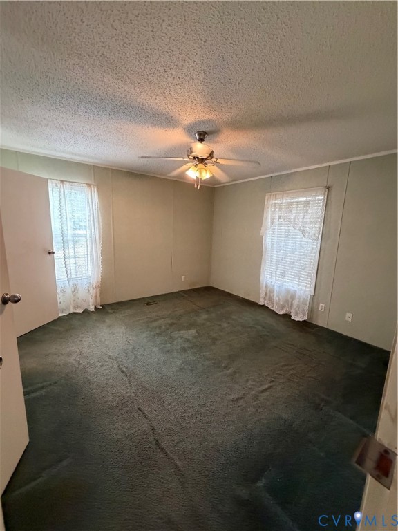 1292 Mt Prospect Road Laneview, VA 22504 - Photo 13 of 25 an empty room with windows and fan