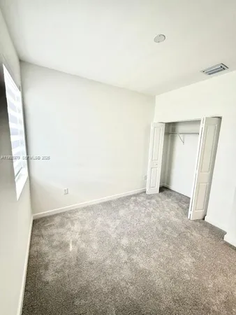 a view of an empty room and a window