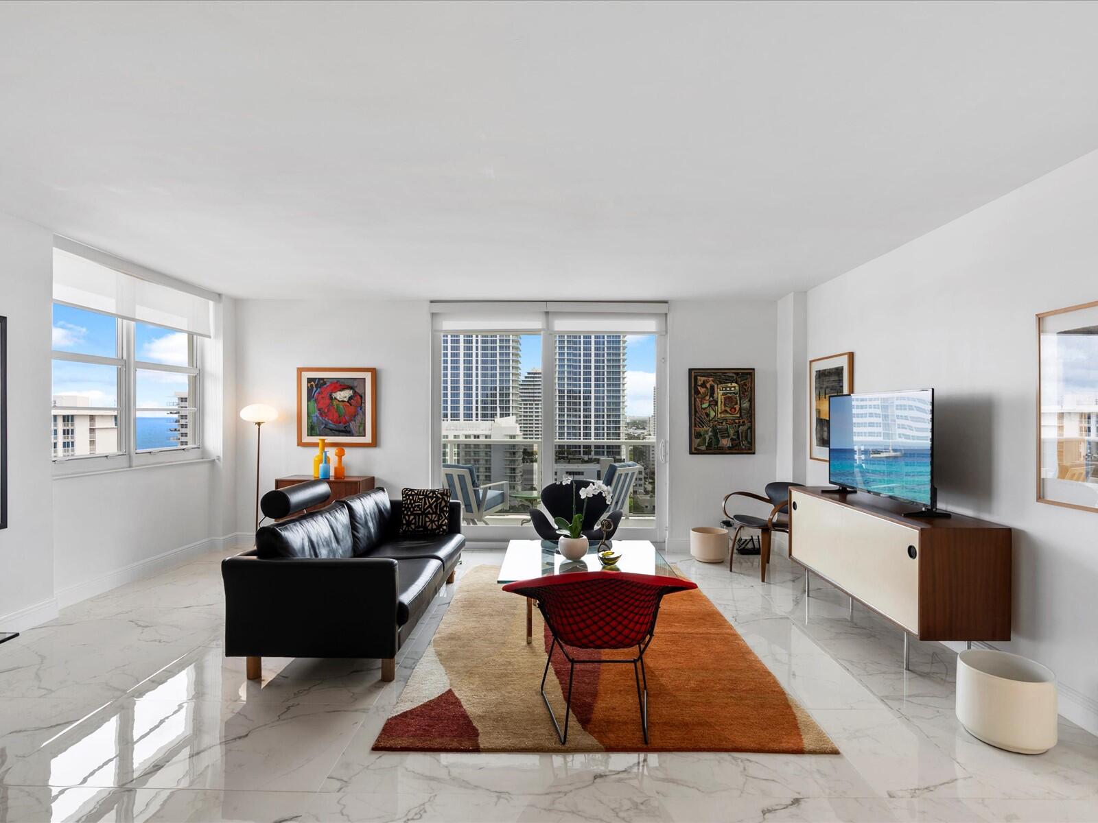 336 North Birch Road, Unit PHI Fort Lauderdale, FL 33304 - Photo 12 of 63 a living room with furniture potted plant and a flat screen tv