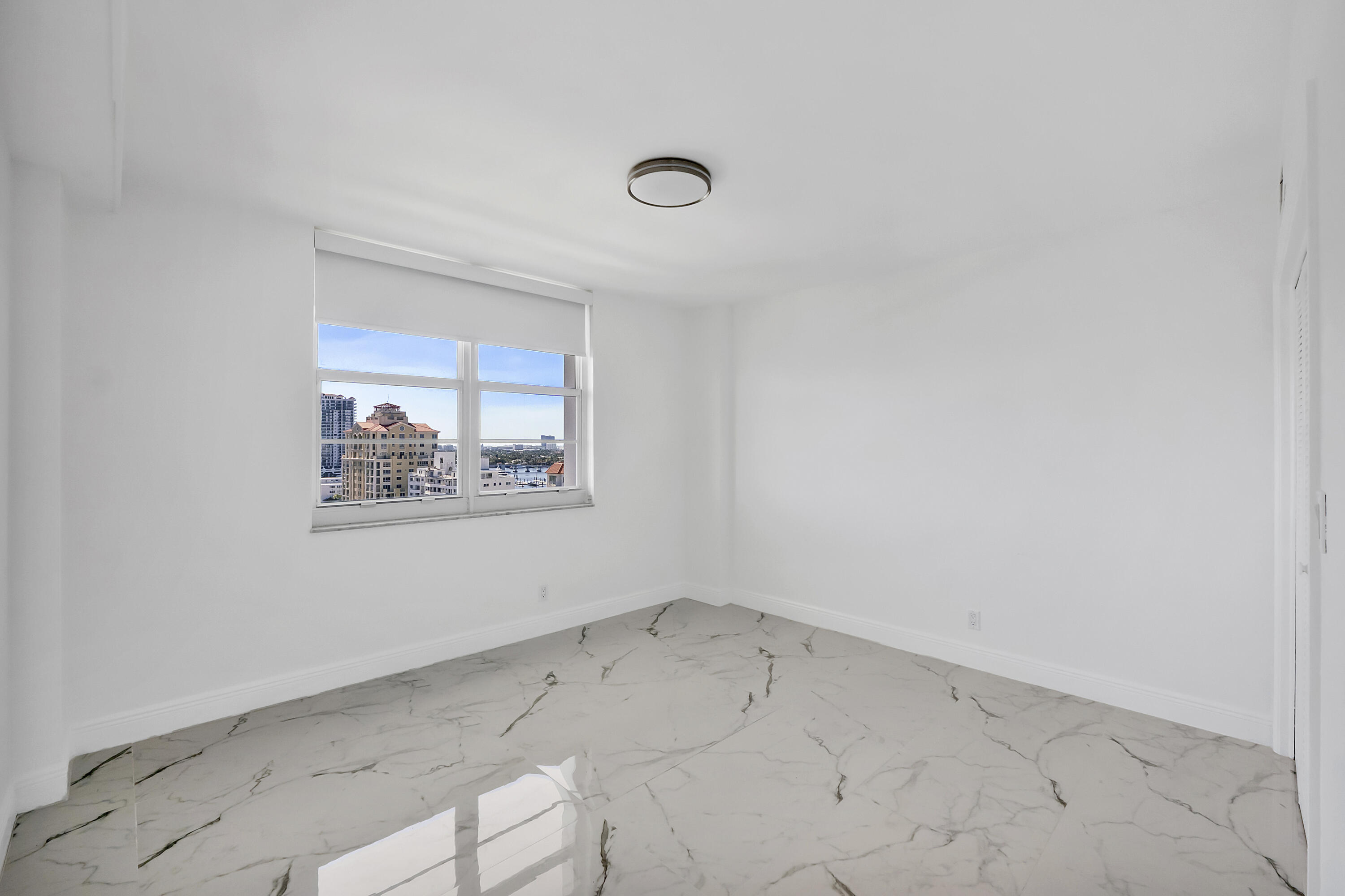 336 North Birch Road, Unit PHI Fort Lauderdale, FL 33304 - Photo 18 of 63 an empty room with a window