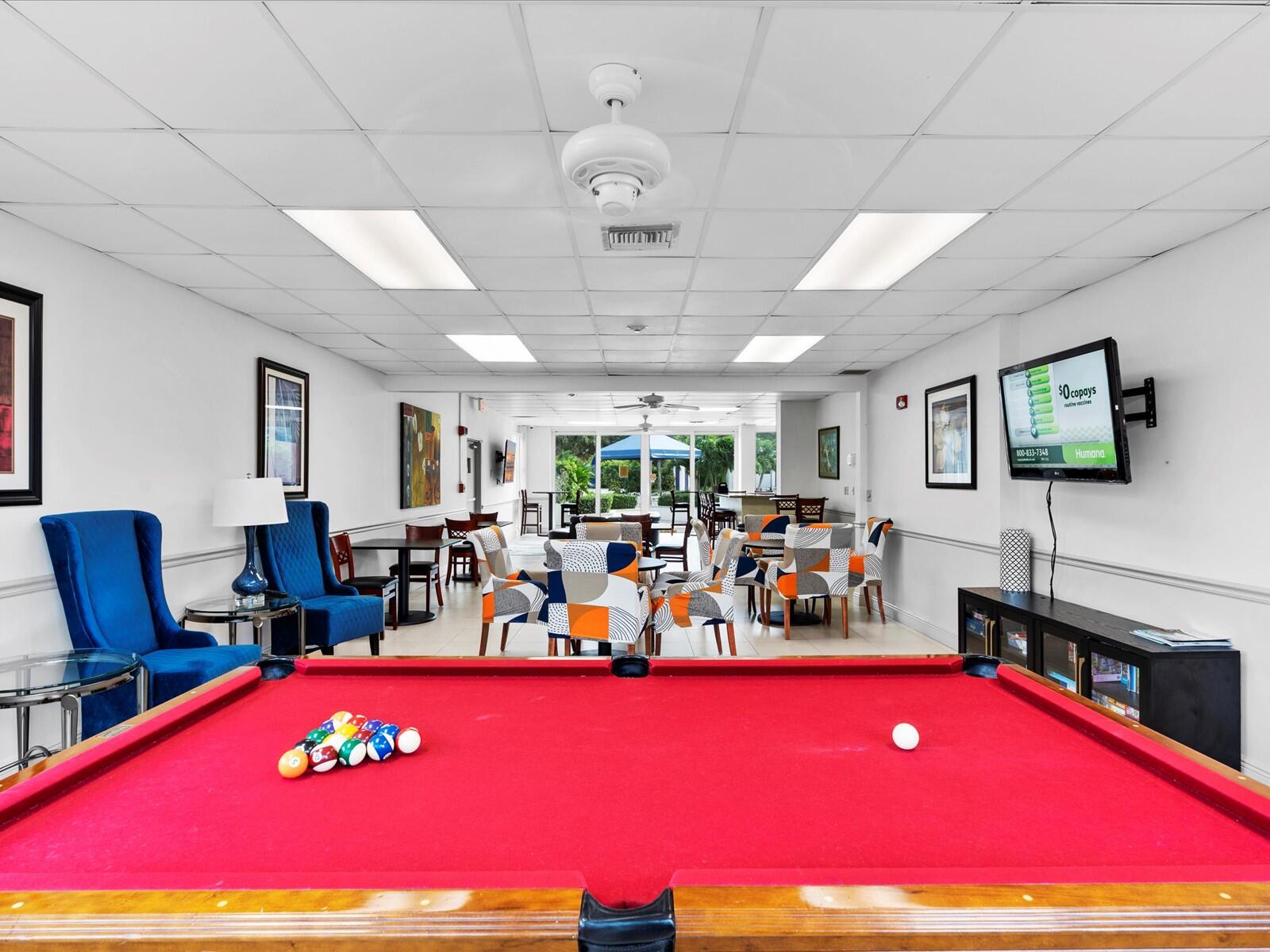 336 North Birch Road, Unit PHI Fort Lauderdale, FL 33304 - Photo 35 of 63 a living room with furniture pool and a flat screen tv