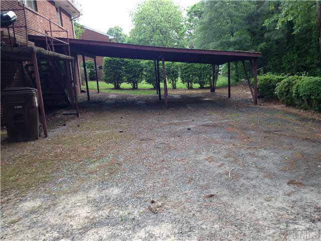606 Ridge Road Roxboro, NC 27573 - Photo 5 of 6 a view of a backyard with large trees and plants