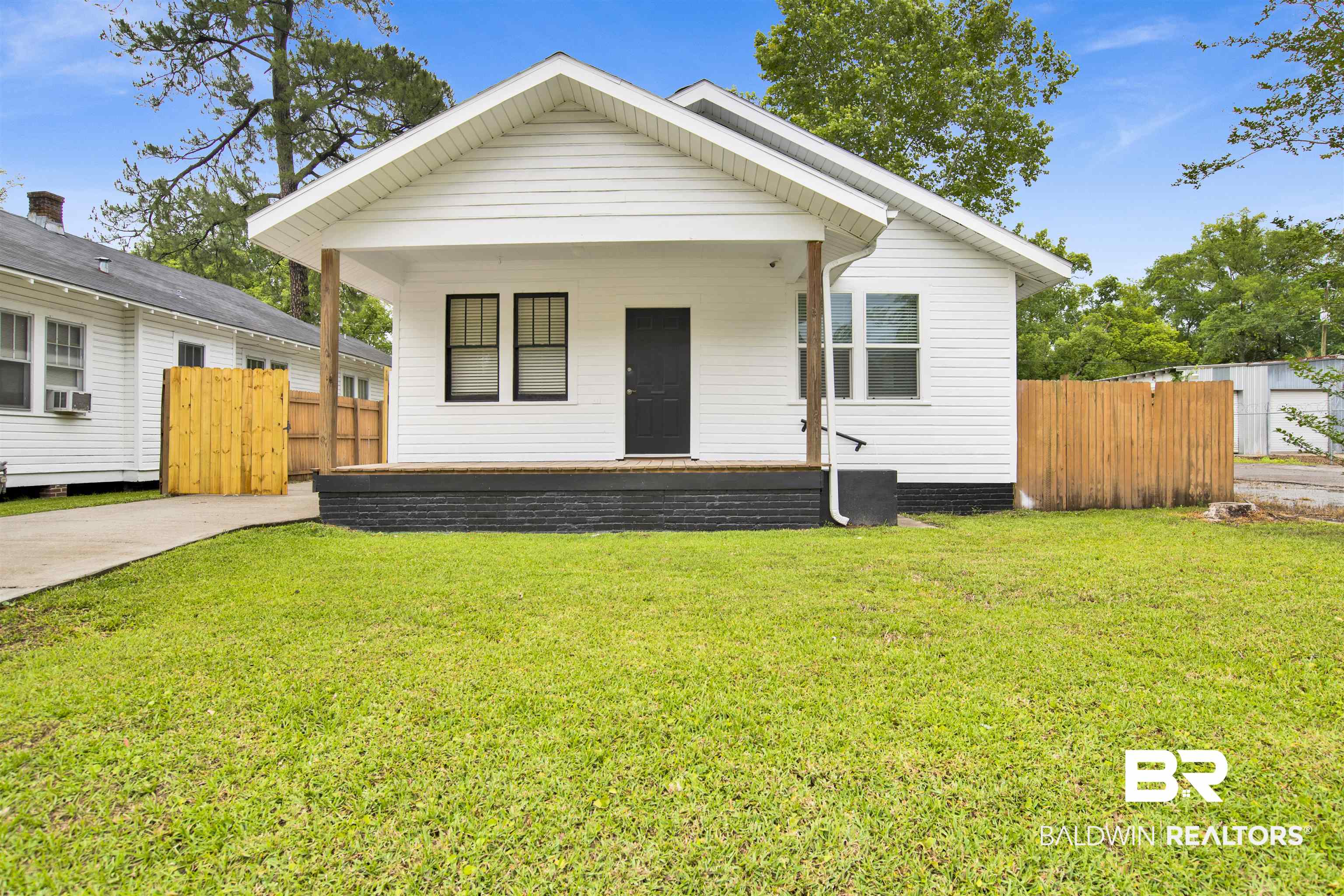 507 Holcombe Avenue Mobile, AL 36606 - Photo 1 of 28 Shotgun-style home with covered porch and cooling unit
