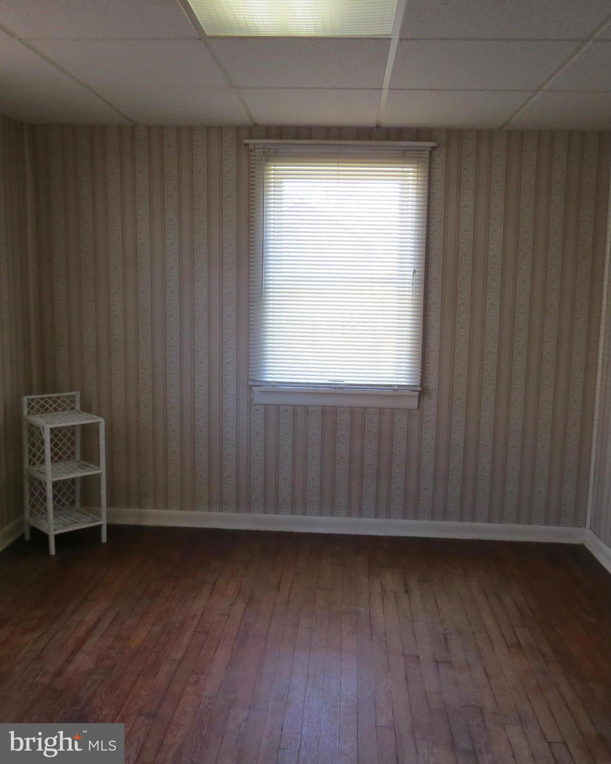 3401 Sollers Point Road Baltimore, MD 21222 - Photo 13 of 29 an empty room with wooden floor and windows