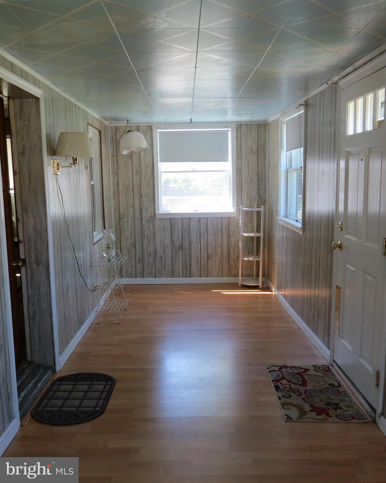 3401 Sollers Point Road Baltimore, MD 21222 - Photo 15 of 29 a view of a hallway with wooden floor and a living room
